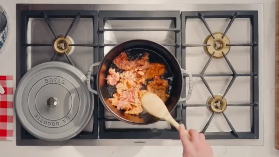 Searing sausage meat undisturbed in Dutch oven to develop fond