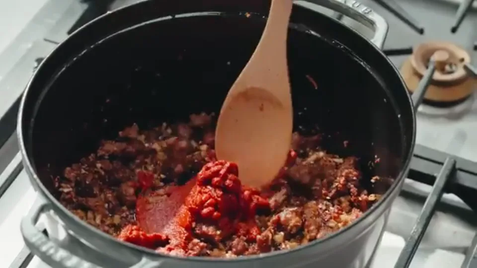 Toasting tomato paste in the pot until deep red