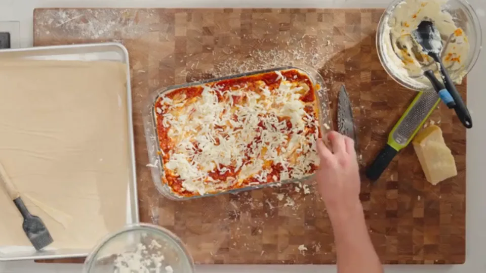 Top layer covered in mozzarella blanket and edged with Parmesan