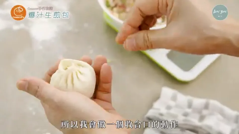 Pinching and sealing the top pleats of the bun