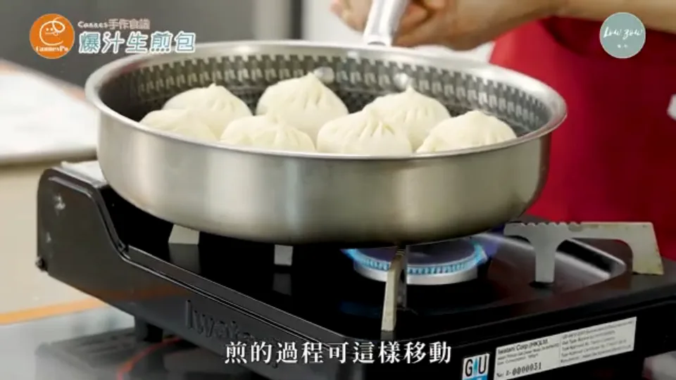 Pan-frying raw buns in an oiled skillet over medium flame