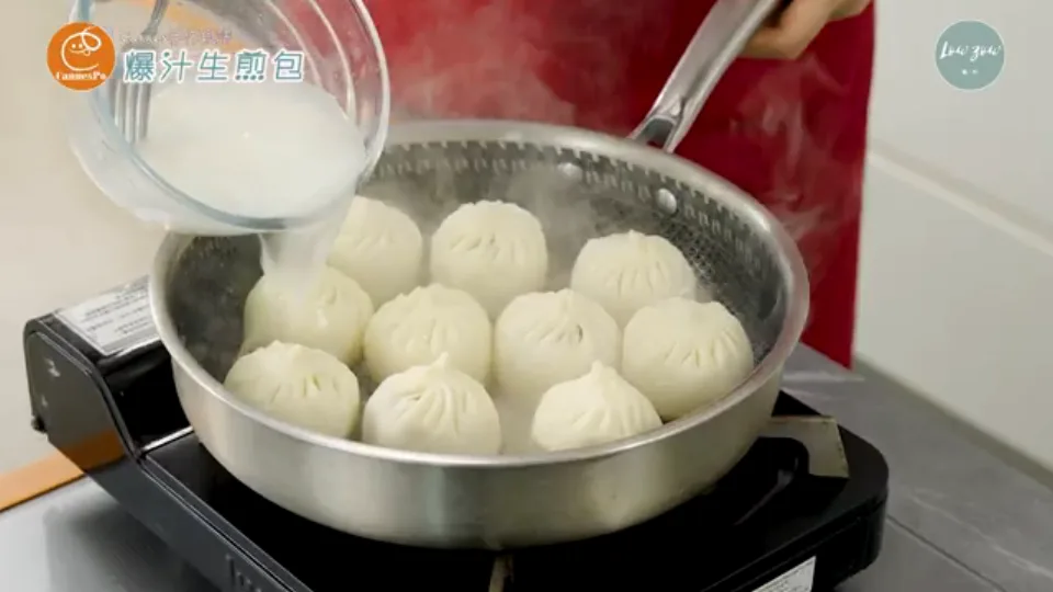 Pouring flour slurry into skillet around buns