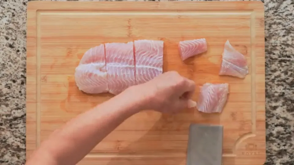 Slice fish along the grain then diagonally into chunks
